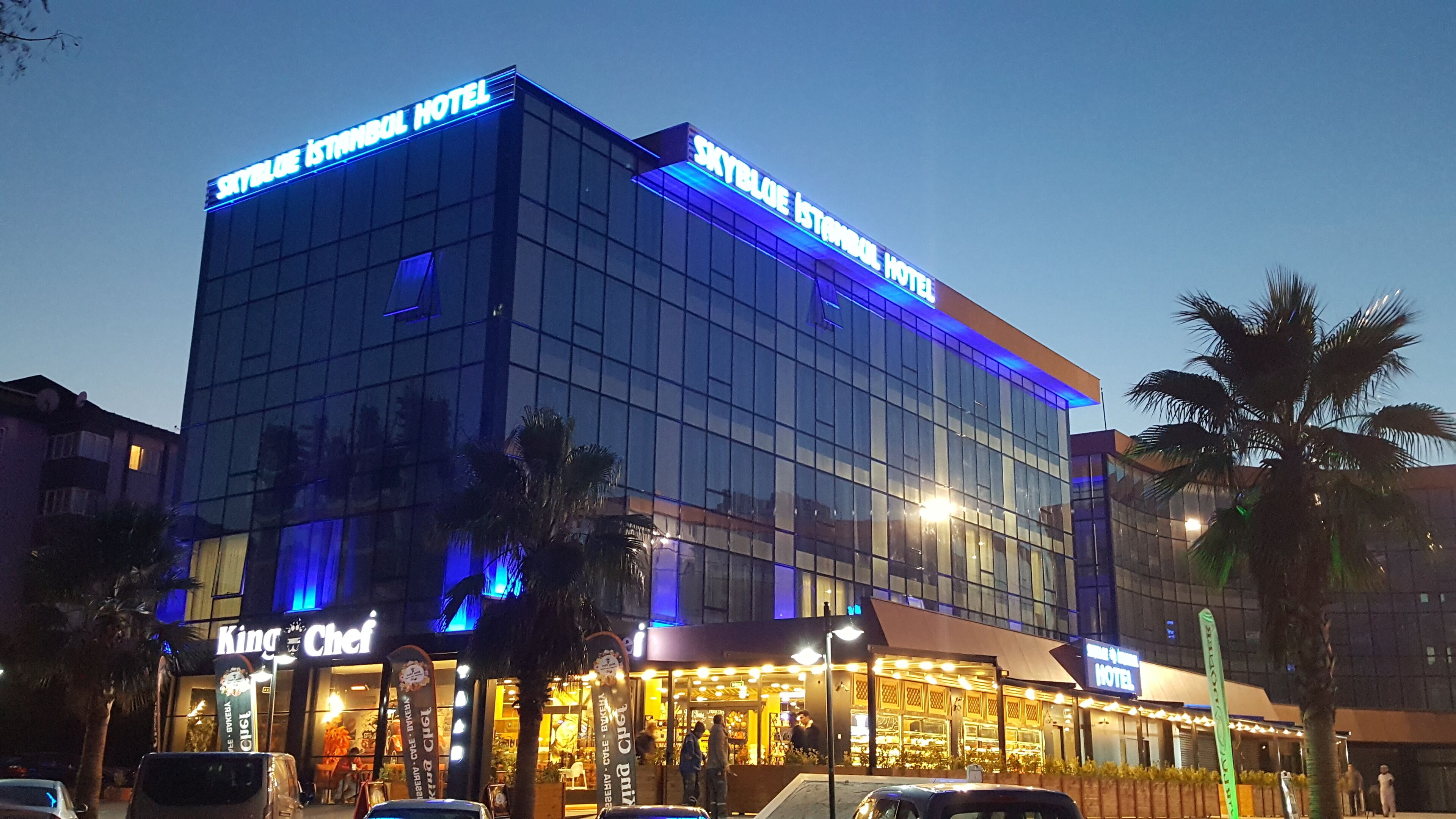 A modern hotel building with "Skyblue Istanbul Hotel" signage.