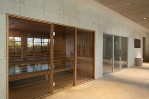 A modern interior with wooden benches, glass doors, and a tiled floor.