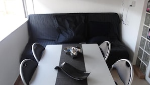 A small room with a white table, two chairs, a black sofa, and a window. - Studio apartment in Vrsi with Terrace, Air condition, WIFI (4824-1) (Vrsi)