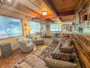 A cozy living room with a sofa set, a coffee table, and a fireplace.