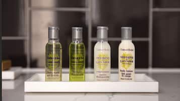 Four bottles of Verbena and Lavender body care products on a white tray.
