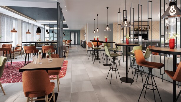 Un restaurante moderno con mesas altas, sillas, iluminación colgante y una zona de bar.