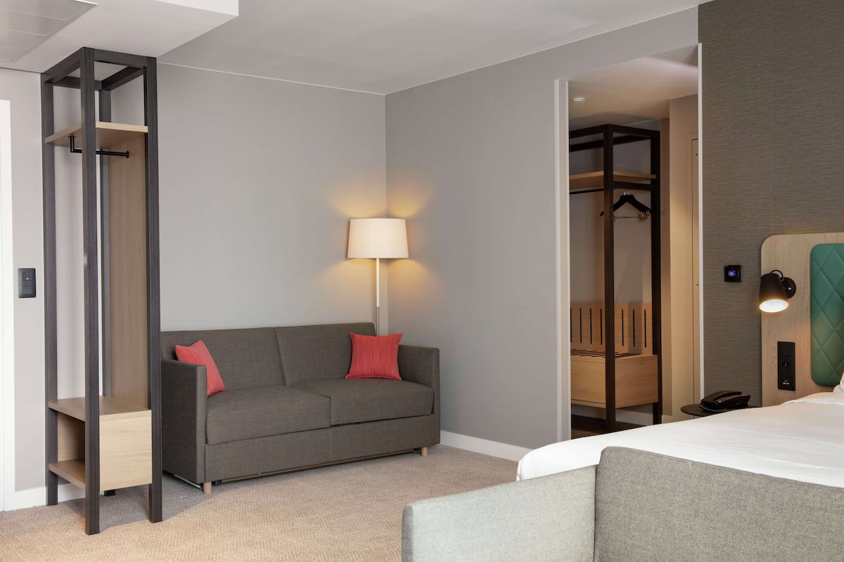 Habitación, 1 cama King size y sofá cama | Área de sala de estar | Smart TV de 55 pulgadas con canales vía satélite y televisión