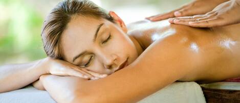 A person receiving a massage, with a focus on the arm and hand.