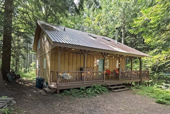 A rustic cabin with a porch, surrounded by dense forest. - Twin Maples | River Access, BBQ (Packwood)