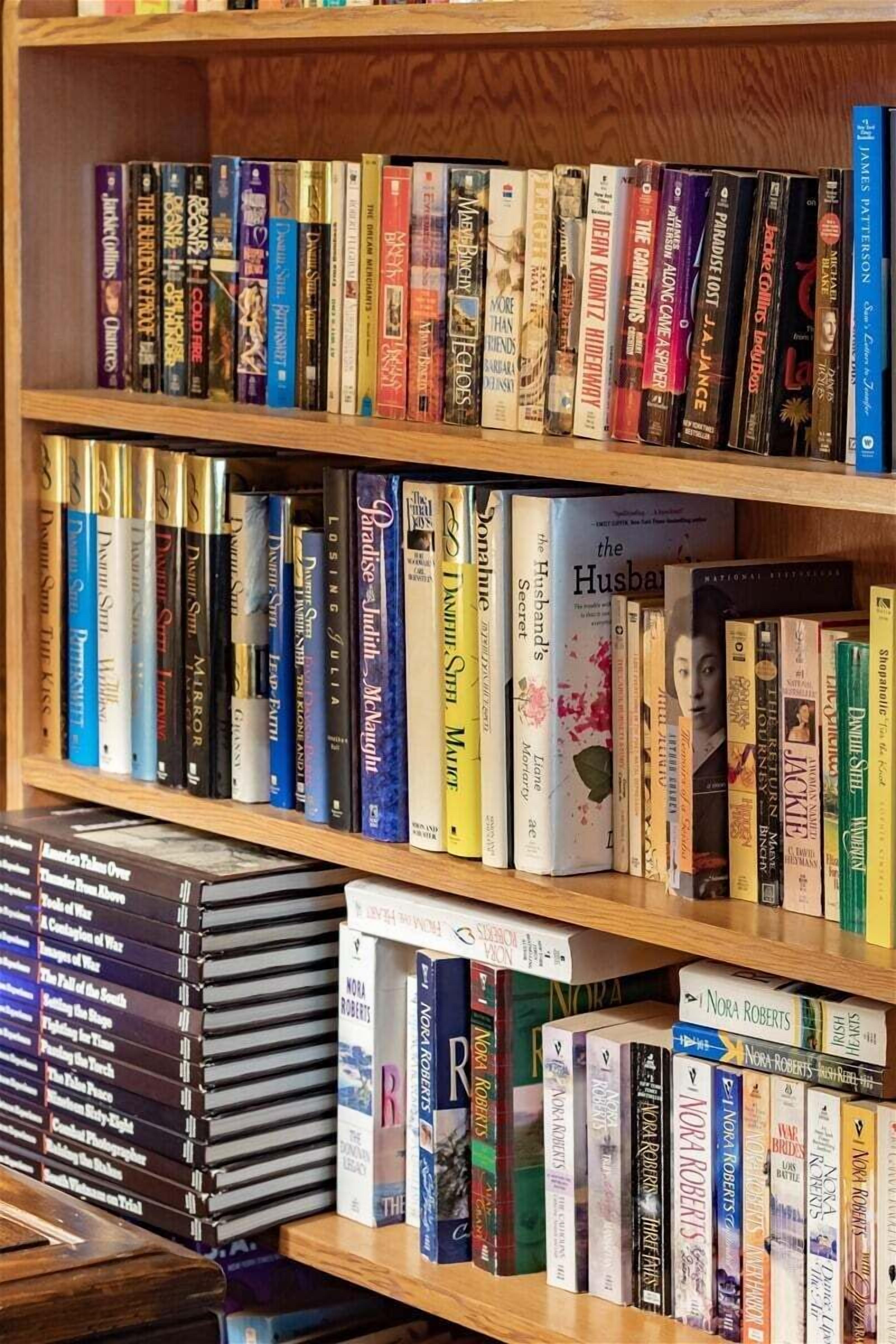 A bookshelf filled with various books, including some with visible titles and authors.