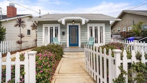 A house with a blue door, white picket fence, and a small porch with chairs. - Bright and Quirky Hillcrest Craftsman (San Diego)