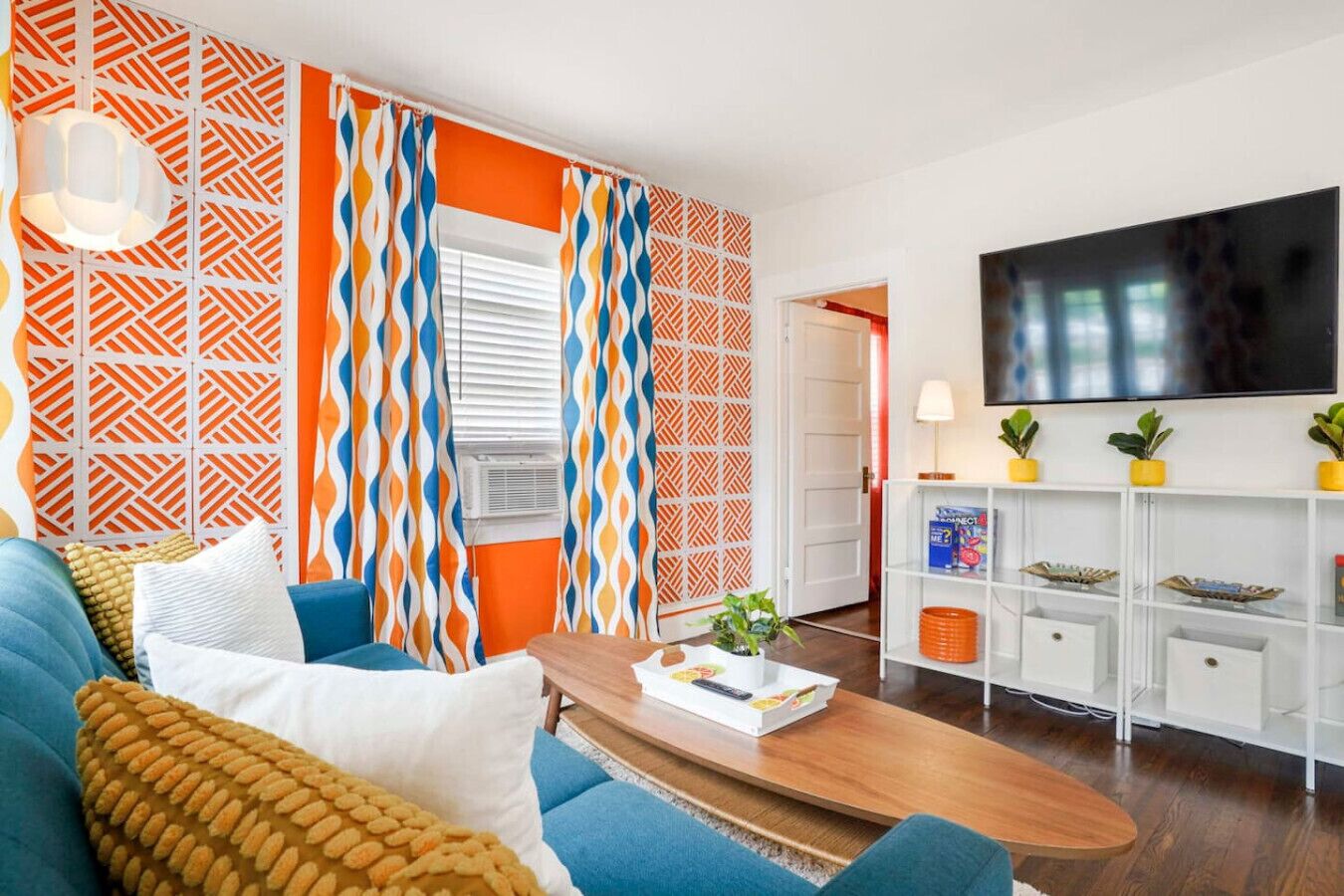 Een moderne woonkamer met een bank, salontafel en televisie.