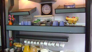 A breakfast buffet setup with various food items and beverages. - Palermo Soho Hostel (Buenos Aires)