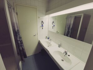 A bathroom with two sinks, a mirror, and a shower curtain. - Nature Hotel (Northern Lights, Ruka, Kitka Lake) (Kuusamo)