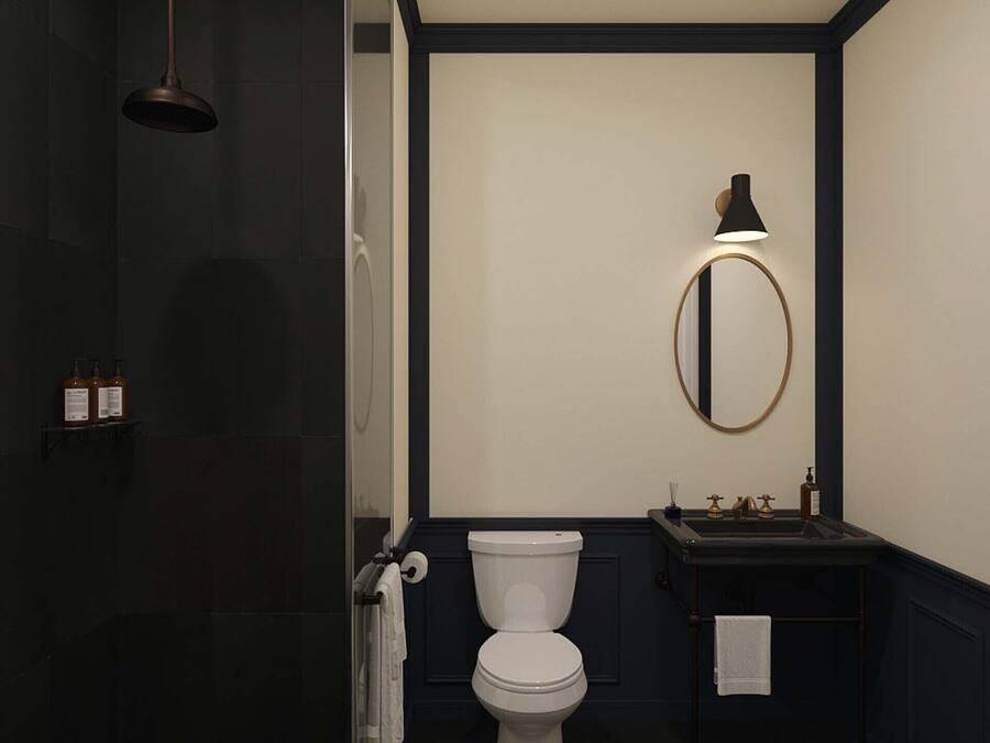 A bathroom with a toilet, a sink, and a mirror.