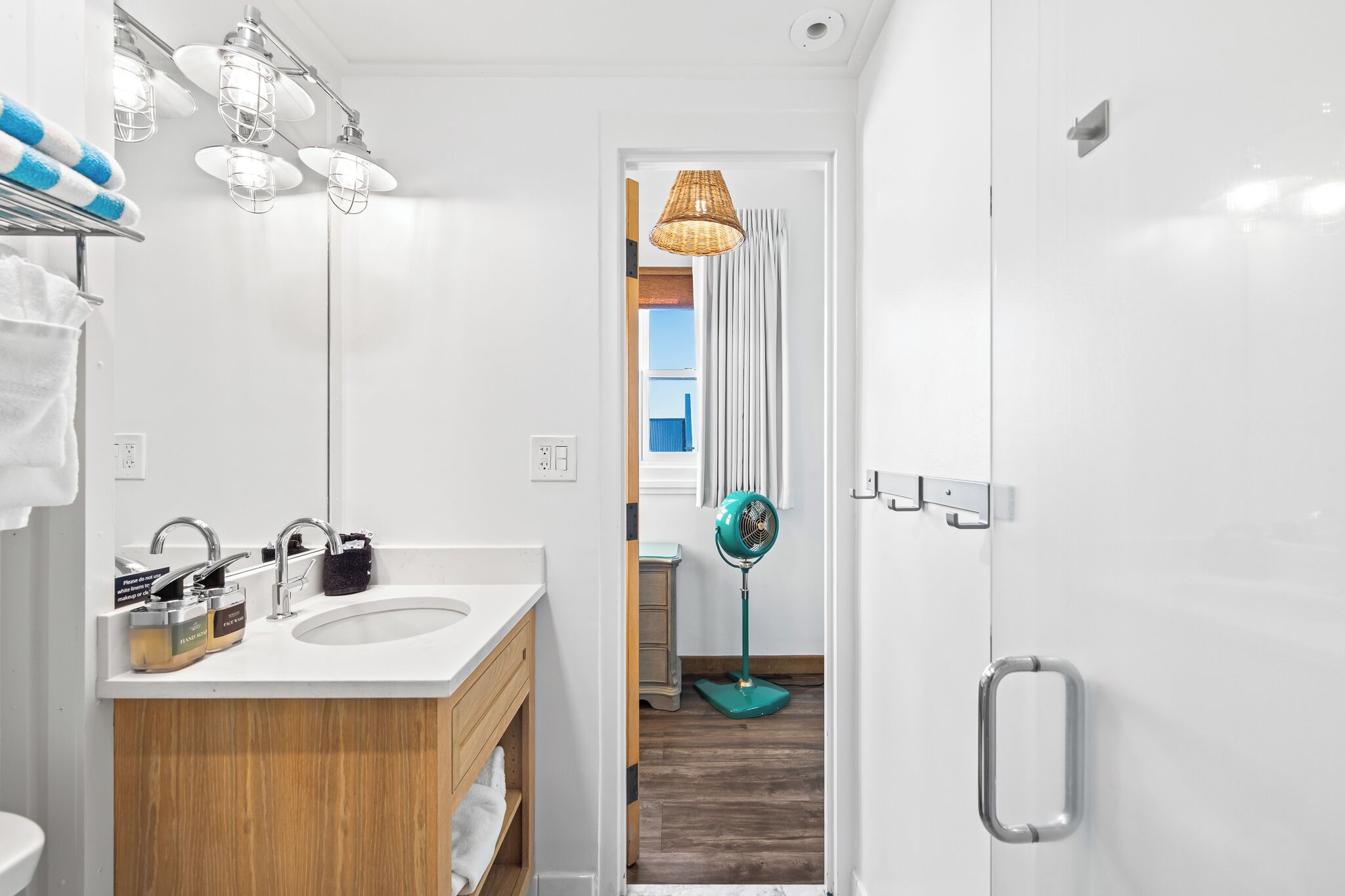 A modern bathroom with two sinks, a mirror, and a shower area.