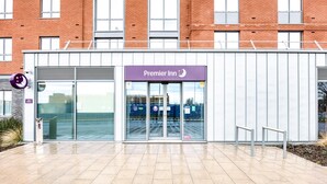 A Premier Inn hotel entrance with a modern design, large glass doors, and a clear view of the parking area. - Premier Inn Wokingham Town Centre (Wokingham)