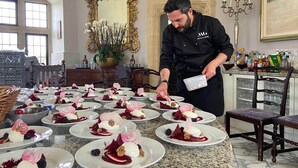 A chef preparing desserts in a well-lit, elegant room with a marble floor, a large mirror, and a chandelier. - Majestic 17th-century castle in stunning Somerset countryside. Pet friendly. (Clevedon)