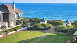 A coastal property with a large house, two small structures, and a well-maintained lawn. - 201 Rosemary Beach Inn - Includes Beach Chairs & Complimentary Breakfast + Access to 4 Pools (Rosemary Beach)