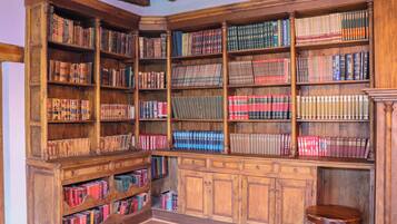 A library with wooden bookshelves filled with books.
