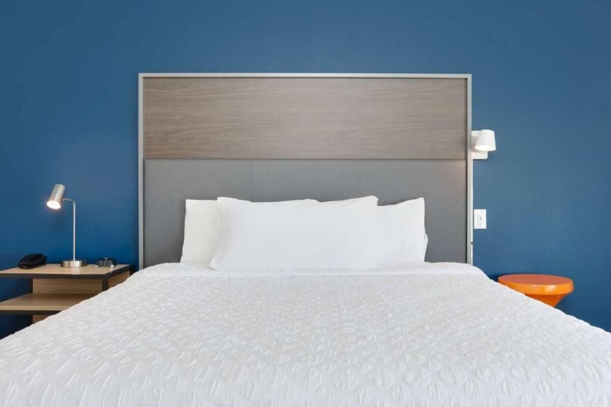 Hypo-allergenic bedding, desk, laptop workspace, blackout drapes