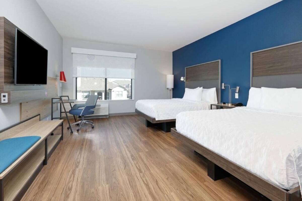 Hypo-allergenic bedding, desk, laptop workspace, blackout drapes
