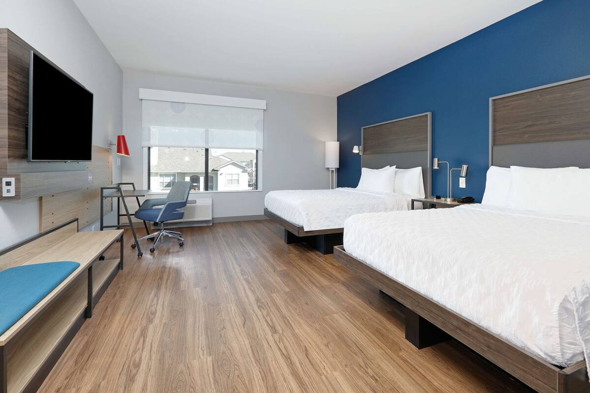Hypo-allergenic bedding, desk, laptop workspace, blackout drapes
