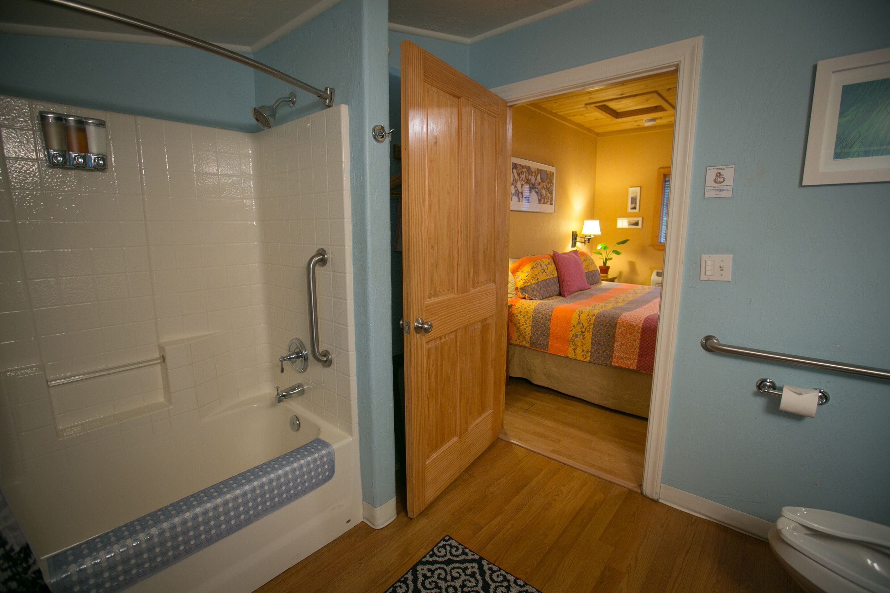 A bathroom with a bathtub, shower, and toilet.