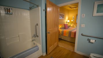 A bathroom with a bathtub, shower, and toilet.