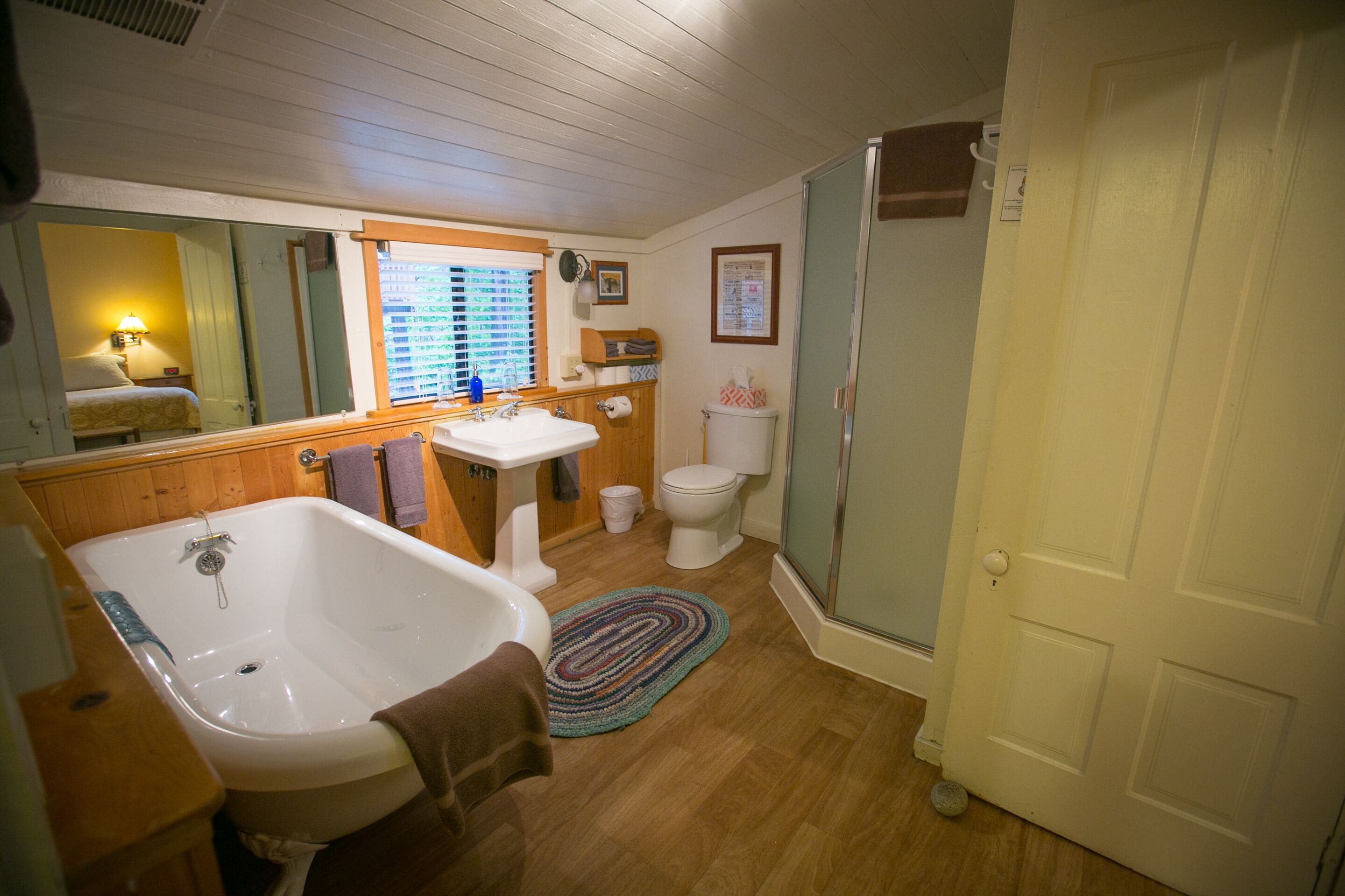 A bathroom with a bathtub, sink, toilet, and shower.