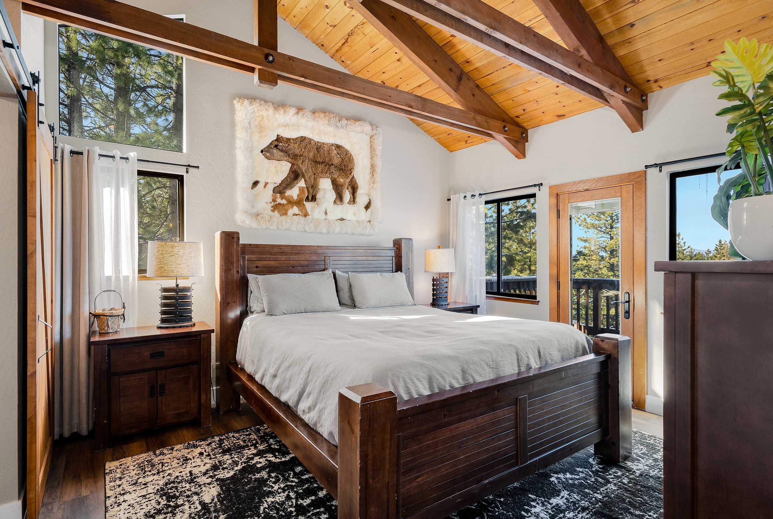 Primary Suite with comfy king bed, rustic wood beams, Tahoe decor & furnishing.