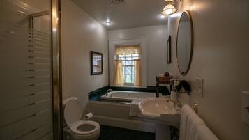 A bathroom with a toilet, sink, and bathtub.