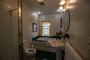 A bathroom with a toilet, sink, and bathtub.