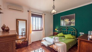 Enjoy a restful stay in this inviting hotel room featuring a comfortable bed, a large mirror, and a dresser.
