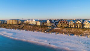 A beachfront property with multiple houses, a sandy beach, and a clear sky. - Bleeker Cottage - SOUTH OF 30A, FREE GYM/TENNIS, PRIVATE POOL (Rosemary Beach)