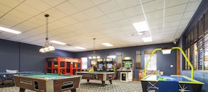 Enjoy games and leisure activities in this indoor space featuring a pool table, billiards table, and dartboard.