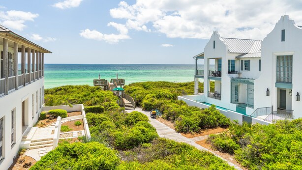 A coastal property with a clear view of the ocean, a wooden pathway, and lush greenery. - Knoepp Cottage & Carriage House - Spectacular Gulf Views, South of 30A (Rosemary Beach)