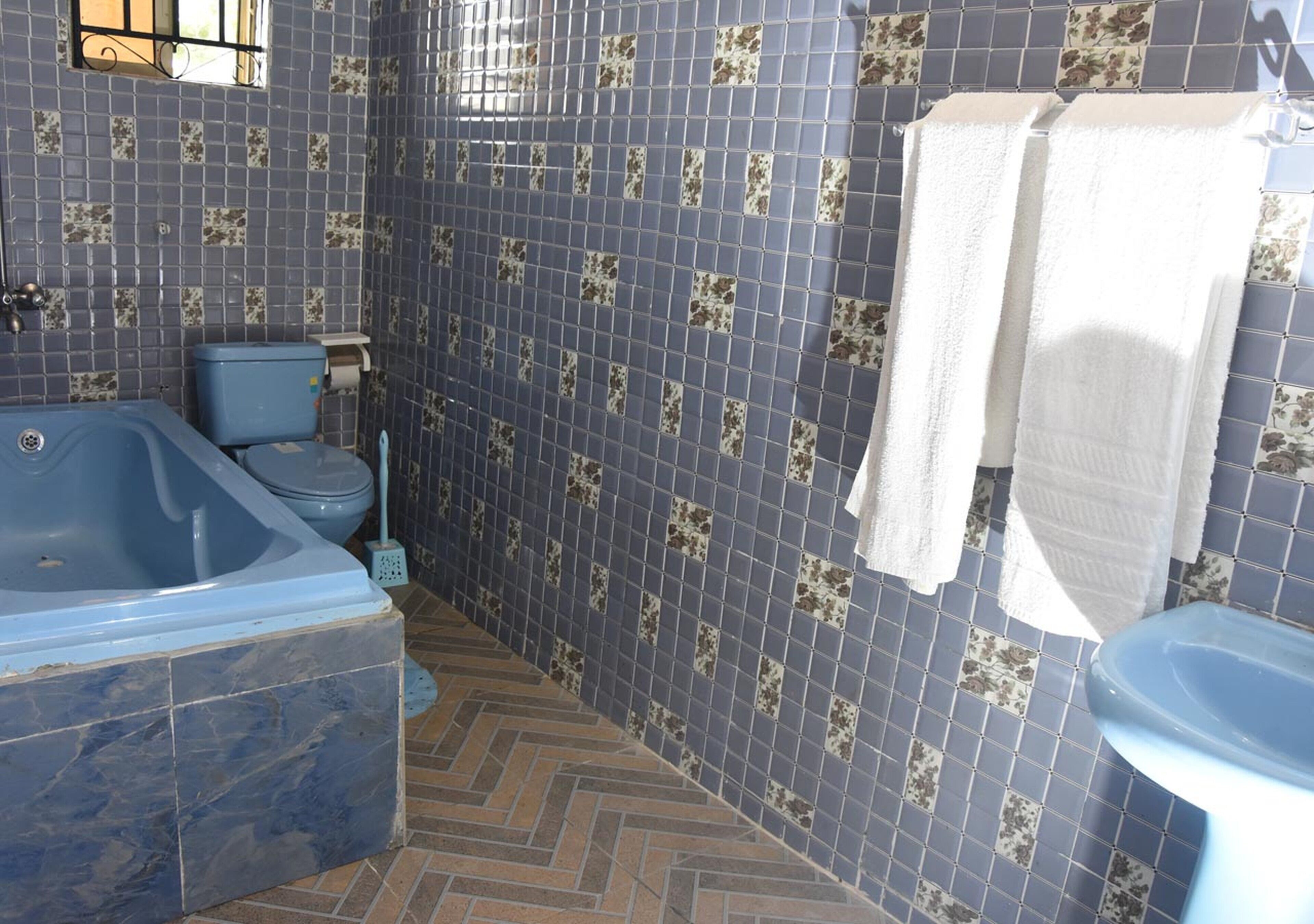 A bathroom with a bathtub, toilet, and sink.