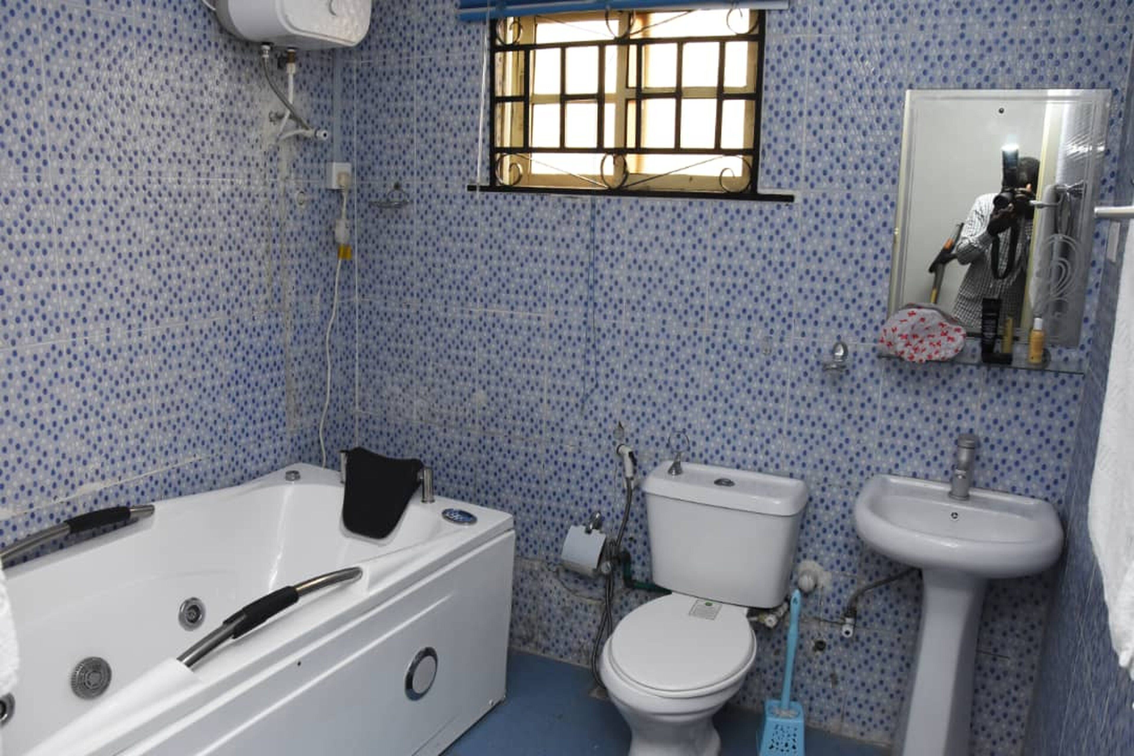 A bathroom with a bathtub, toilet, and sink.