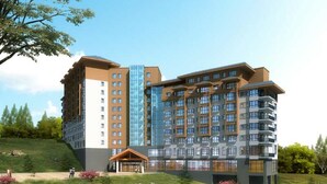 A multi-story hotel with a modern design, featuring a mix of glass and brick facades, and a central courtyard with a wooden pavilion. - Holiday Inn Jilin Beidahu by IHG (Jilin)