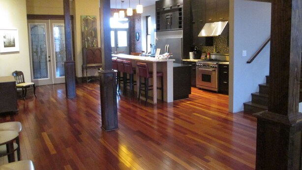 A spacious kitchen with a central island, wooden flooring, and modern appliances. - Modern meets Historic, Natural Lighting + High Ceilings, Near Metro (Belleville)