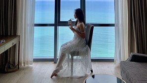 A room with a large window offering a view of the sea. - Holi Panorama Condotel (Nha Trang)