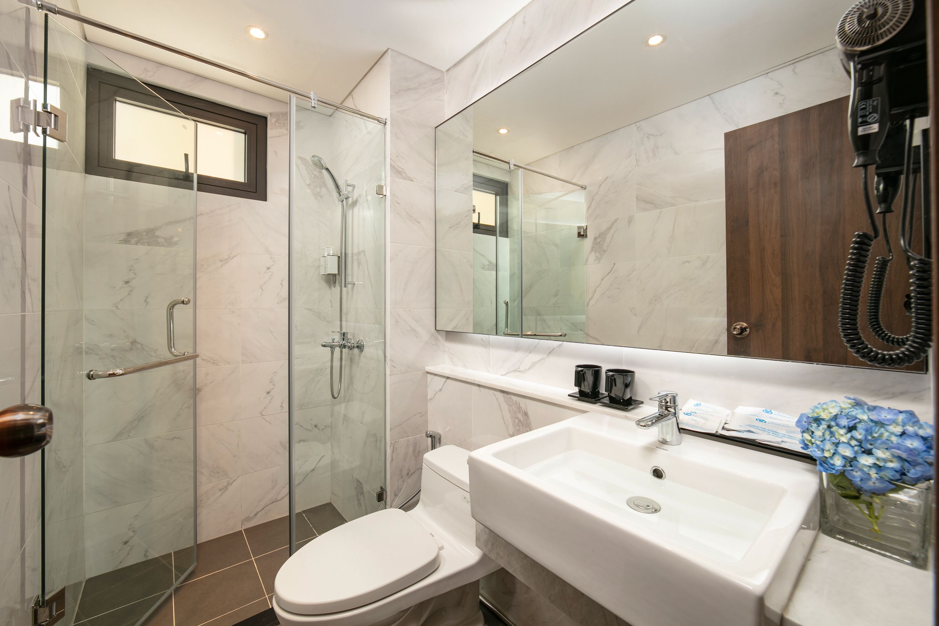 family room | bathroom | shower, rainfall showerhead, designer toiletries, hair dryer