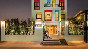 A multi-story hotel with colorful window frames and a sign for 'VIRVLA Boutique Hotel'. - Viryla Boutique Hotel (Vientiane)