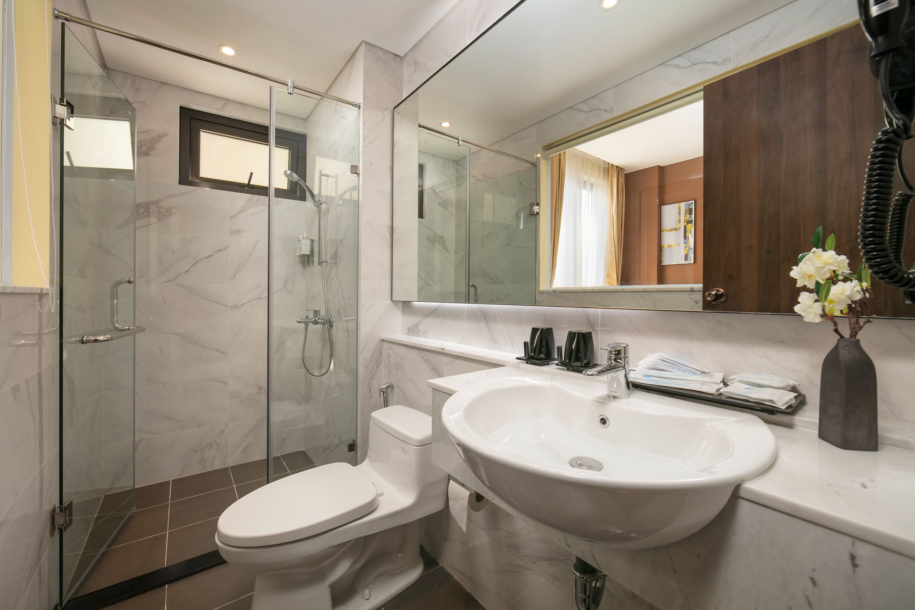deluxe room | bathroom | shower, rainfall showerhead, designer toiletries, hair dryer
