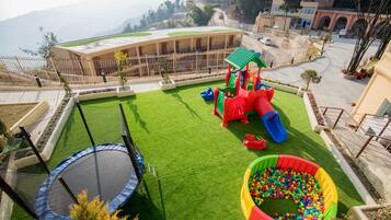A playground with a slide, a ball pit, and a trampoline.