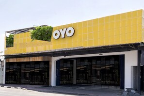 A building with a yellow facade and the word "OYO" prominently displayed.