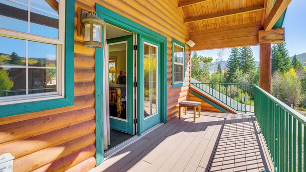 A wooden cabin with a covered porch, a staircase leading to a deck, and a view of the surrounding landscape. - Walk to Frisco Marina! Spacious Family Retreat (Frisco)