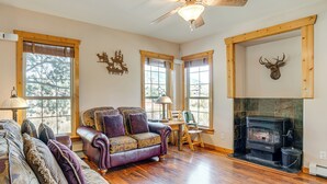 A cozy living room with a fireplace, leather sofas, and a dining area. - Walk to Frisco Marina! Spacious Family Retreat (Frisco)