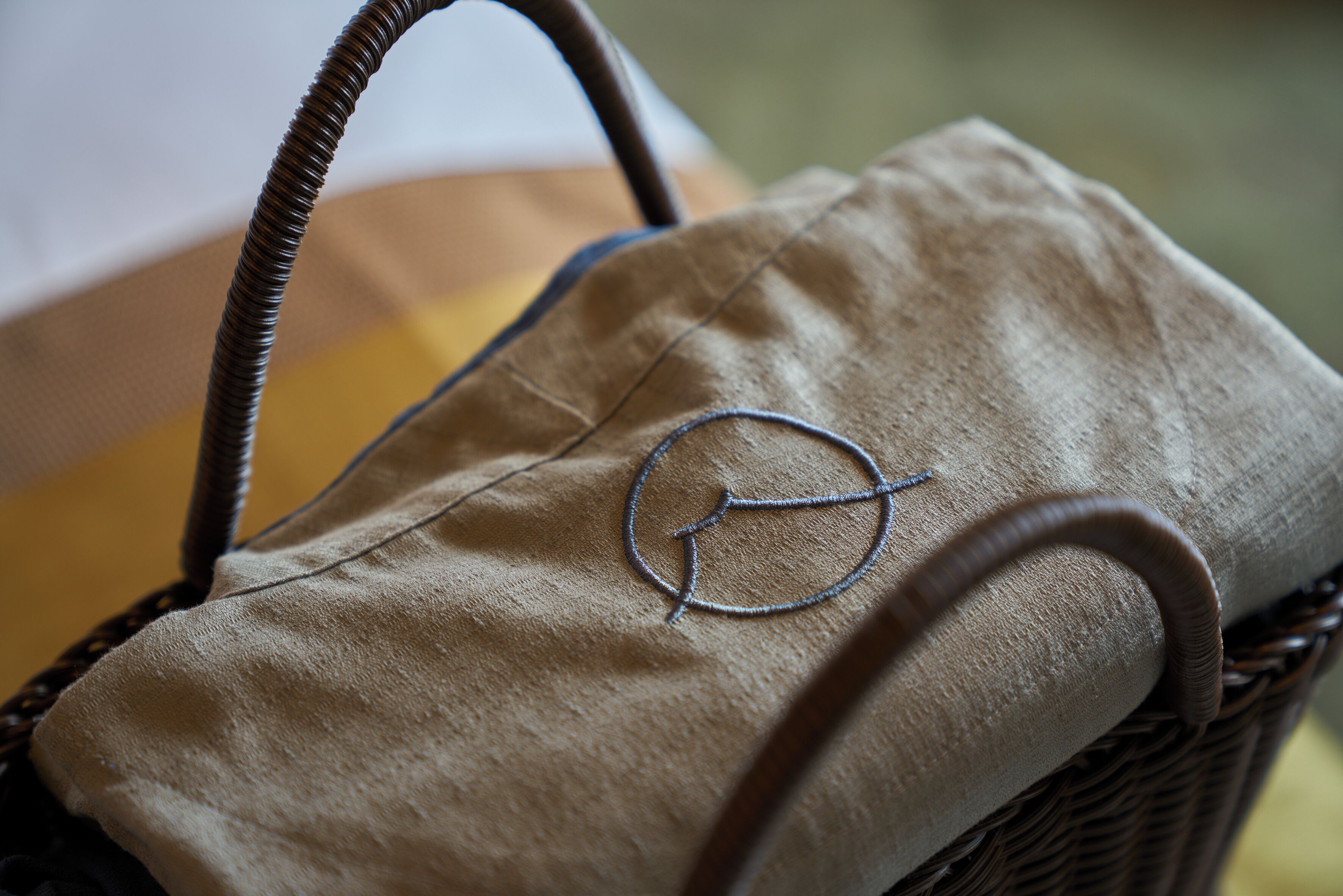 A woven basket with a fabric bag inside.