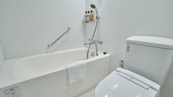 Combined shower/tub, free toiletries, hair dryer, slippers