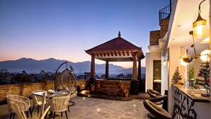 An outdoor patio with a gazebo, seating area, and a bar. - Arushi Boutique Hotel (Kathmandu)