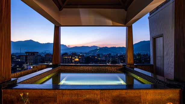 A rooftop pool with a cityscape view at dusk. - Arushi Boutique Hotel (Kathmandu)