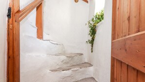 A staircase with white walls and wooden railings. - Castle Lodge (Keswick)